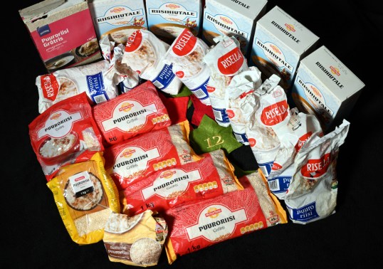 Avattuja ja avaamattomia puuroriisi- ja riisihiutalepakkauksia.